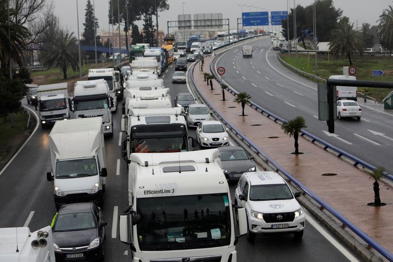 &copy; Reuters. Truckers stage slow march amid strike for better working conditions in Valencia, Spain, March 21, 2022. REUTERS/Eva Manez