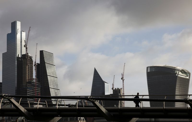 &copy; Reuters. FILE PHOTO: The City of London financial district is seen as people walk over Millennium Bridge in London, Britain, February 16, 2022. REUTERS/Henry Nicholls