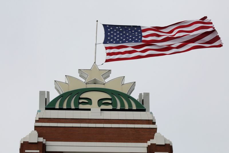 © Reuters. A flag flies above the company's headquarters as Starbucks Corp opens the first upscale Starbucks Reserve store at the Starbucks headquarters in Seattle, Washington, U.S., February 27, 2018.  REUTERS/David Ryder