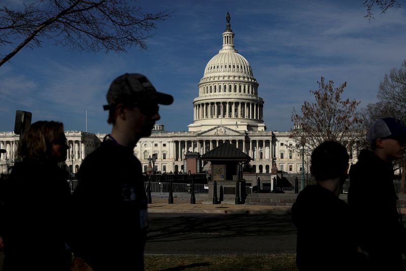 &copy; Reuters. FILE PHOTO: Pedestrians walk by the United States Capitol building in Washington, U.S. March 15, 2022. REUTERS/Emily Elconin/File Photo