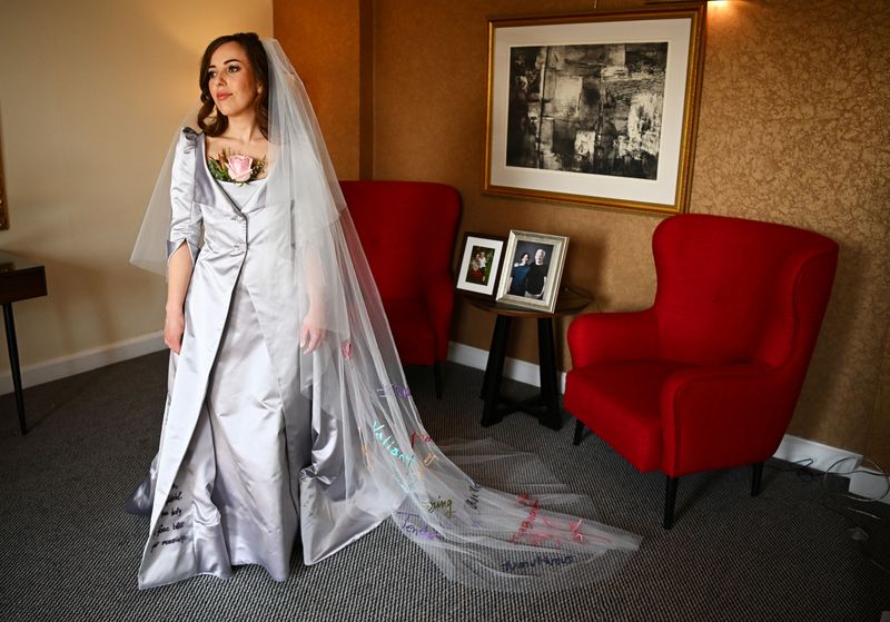 © Reuters. Stella Moris, the partner of Wikileaks founder Julian Assange, is photographed in her Vivienne Westwood designed wedding dress before driving to Belmarsh Prison where she is due to marry Julian Assange, at a hotel in London, Britain March 23, 2022.   REUTERS/Dylan Martinez/Pool