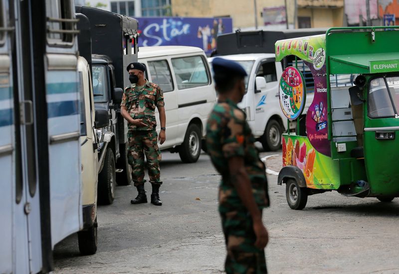 &copy; Reuters. FILE PHOTO: Sri Lanka's Army members stand guard at a Ceylon Petroleum Corporation fuel station to help stations distribute oil during the fuel crisis, in Colombo, Sri Lanka March 22, 2022. REUTERS/Dinuka Liyanawatte/File Photo