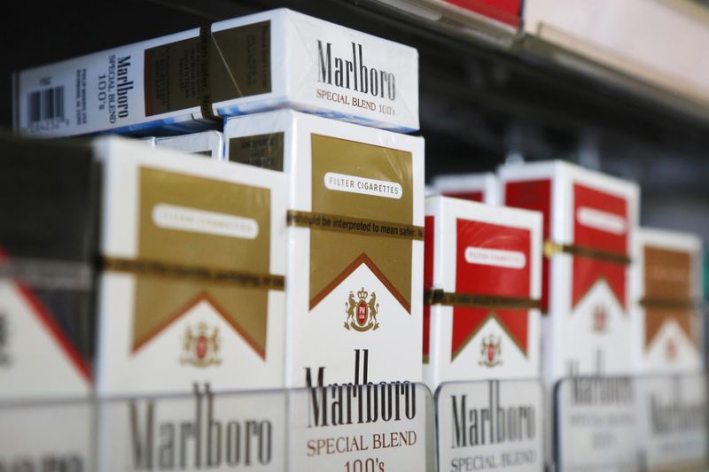 &copy; Reuters. FILE PHOTO: Packs of Marlboro cigarettes are displayed for sale at a convenience store in Somerville, Massachusetts July 17, 2014.  Cigarette maker Philip Morris International Inc cut its earnings forecast for 2014 and said it is proving to be a "complex 