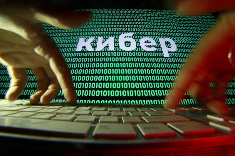 &copy; Reuters. FILE PHOTO: Hands are seen on a keyboard in front of a displayed cyber code in this picture illustration taken October 4, 2018. REUTERS/Dado Ruvic