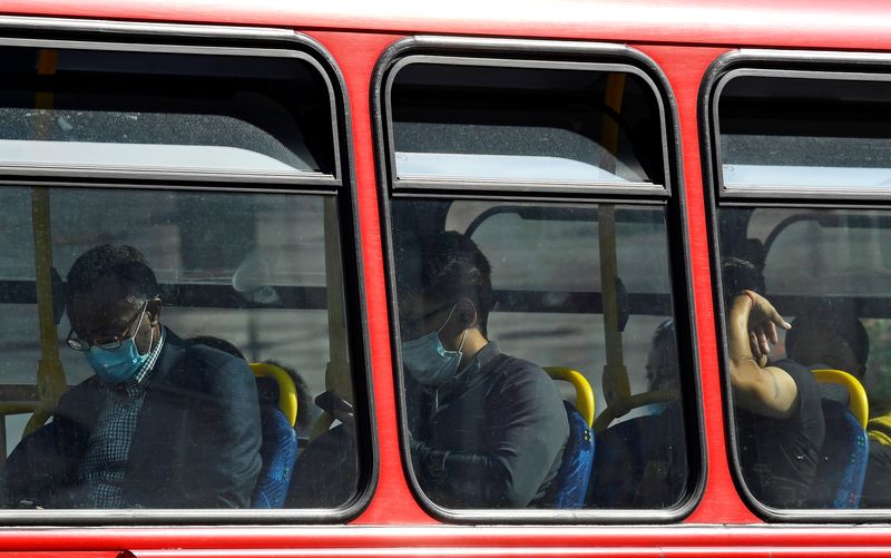 &copy; Reuters. FILE PHOTO: Passengers wear protective face coverings on a London bus, whilst the reproduction "R" number of COVID-19 infections in the United Kingdom has risen and may be above 1, the Government Office for Science said on Friday, indicating a risk that t