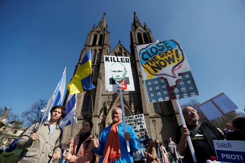 &copy; Reuters. Des membres de la communauté russe de Prague participent à une manifestation contre la guerre en Ukraine. Des milliers de Russes - 3.000 selon la police - ont défilé samedi à Prague, où ils ont brandi des drapeaux blanc et bleu pour protester contre