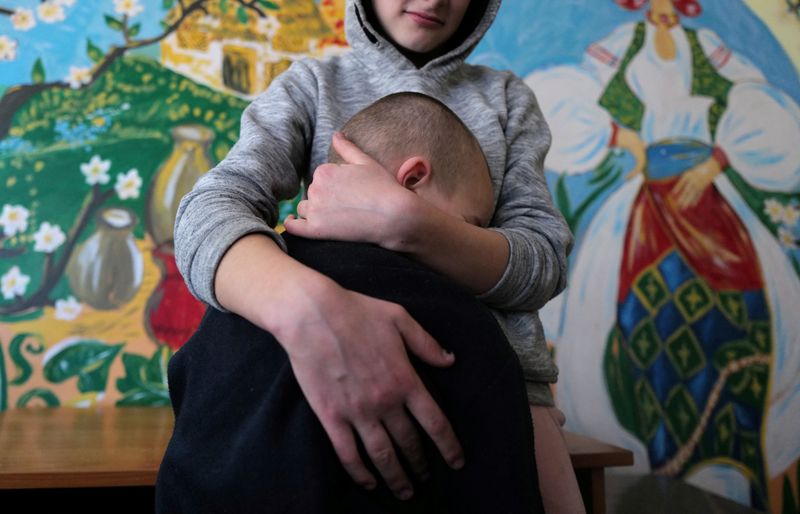 &copy; Reuters. Sophia, 16, who was taken away from her widowed mother along with her siblings, hugs her brother Mykhaylo, 8, at a state shelter in Lviv, Ukraine March 23, 2022. REUTERS/Zohra Bensemra