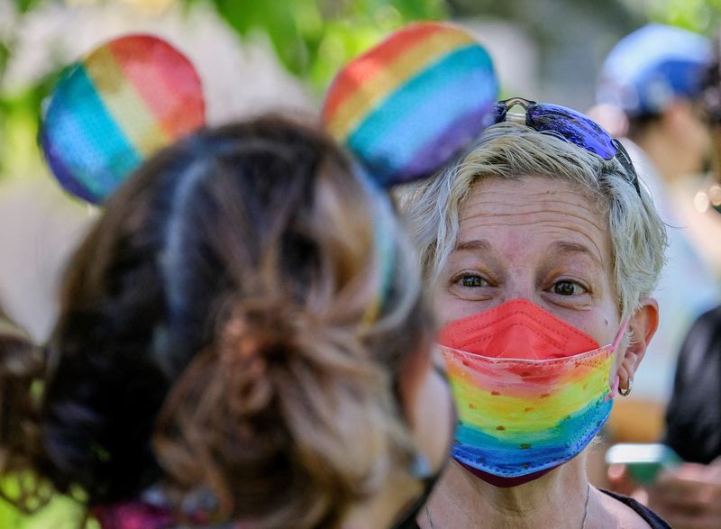© Reuters. FILE PHOTO: A demonstrator wearing a rainbow colour face mask takes part in a protest as Disney's employees demonstrate against Florida's 