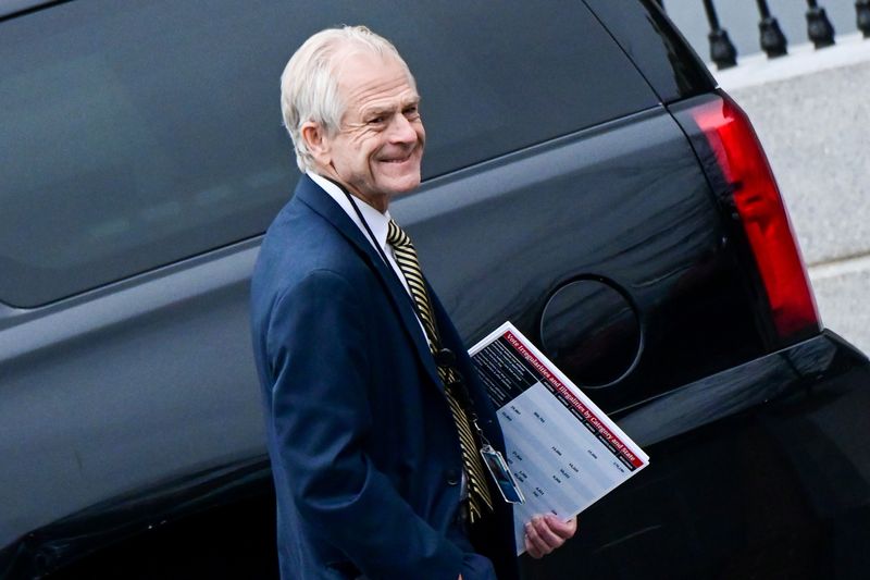 &copy; Reuters. FILE PHOTO: White House advisor Peter Navarro leaves the West Wing carrying a poster board displaying claims of voting irregularity at the White House in Washington, U.S., January 15, 2021. REUTERS/Erin Scott