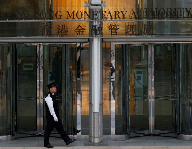 &copy; Reuters. FILE PHOTO: An attendant walks outside the entrance to Hong Kong Monetary Authority in Hong Kong, China November 10, 2015.REUTERS/Bobby Yip/File Photo