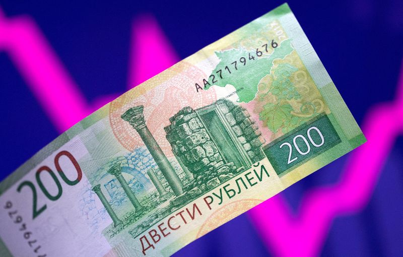 &copy; Reuters. FILE PHOTO: A Russian rouble banknote is seen in front of a descending and rising stock graph in this illustration taken March 1, 2022. REUTERS/Dado Ruvic