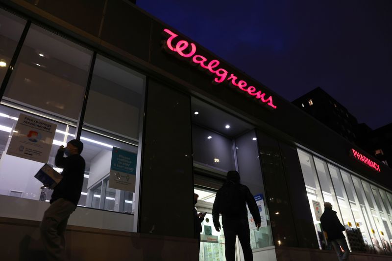 &copy; Reuters. FILE PHOTO: People walk by a Walgreens, owned by the Walgreens Boots Alliance, Inc., in Manhattan, New York City, U.S., November 26, 2021. REUTERS/Andrew Kelly