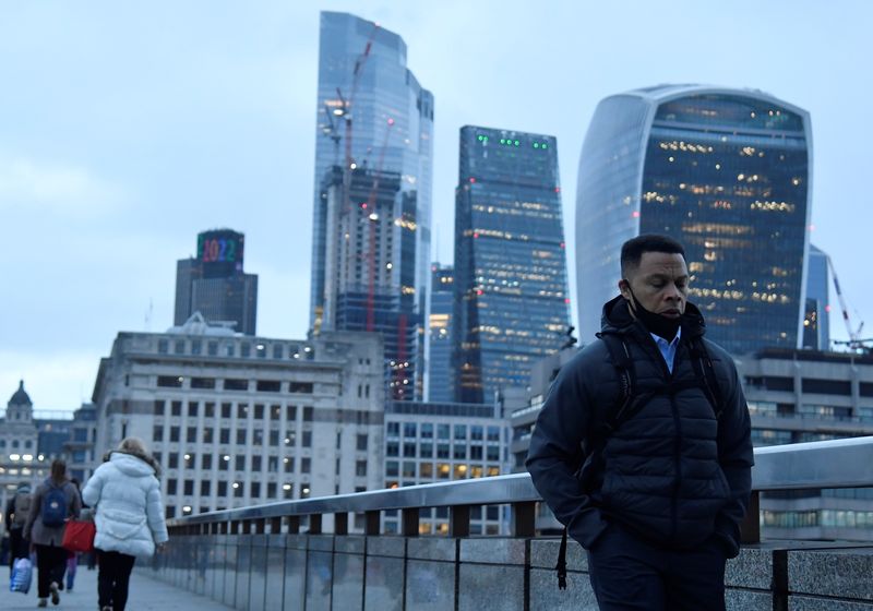 &copy; Reuters. Workers cross London Bridge, with the City of London financial district seen behind, during the morning rush-hour, as the coronavirus disease (COVID-19) lockdown guidelines imposed by British government encourage working from home, in London, Britain, Jan