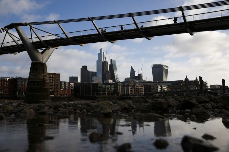 &copy; Reuters. FILE PHOTO: The City of London financial district is seen as people walk over Millennium Bridge in London, Britain, February 16, 2022. REUTERS/Henry Nicholls