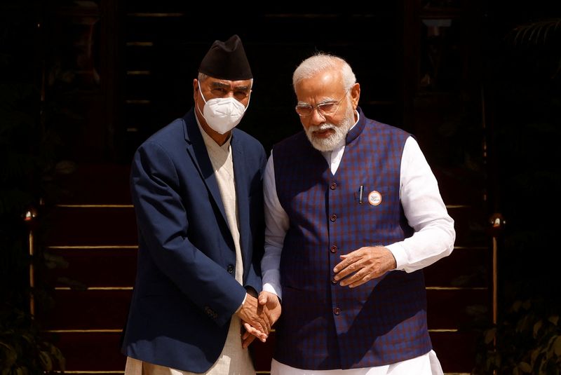 &copy; Reuters. Nepal's Prime Minister Sher Bahadur Deuba speaks his Indian counterpart Narendra Modi ahead of their meeting at Hyderabad House in New Delhi, India April 2, 2022. REUTERS/Adnan Abidi