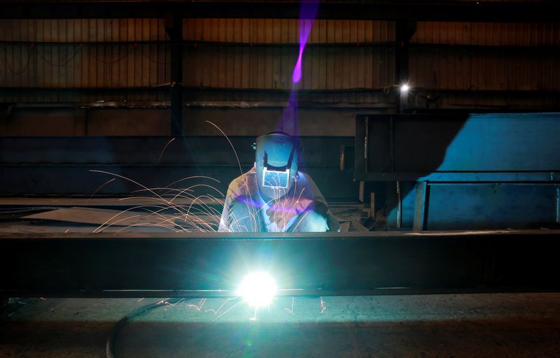 &copy; Reuters. FILE PHOTO: A labourer welds an iron pillar at a building material factory in an industrial area in Dasna, in the central Indian state of Uttar Pradesh, India, January 9, 2019. REUTERS/Adnan Abidi