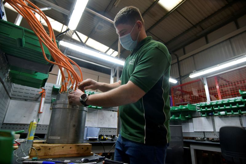 &copy; Reuters. FILE PHOTO: An employee at Advanced Electric Machines works on test models of a motor for an electric vehicle that does not include either rare earth magnets or copper and uses electrical steel and aluminium instead, in Washington, Britain, November 26, 2