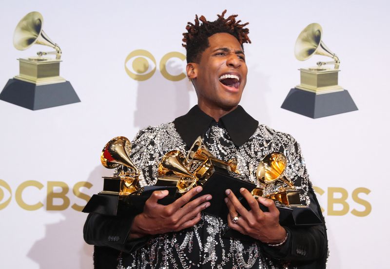 © Reuters. Jon Batiste poses with their Grammys for Best American Roots Performance for 