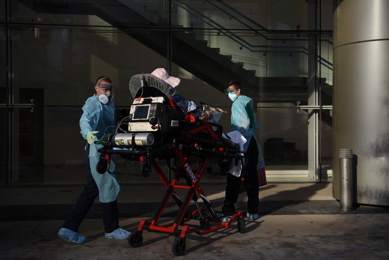 &copy; Reuters. FILE PHOTO: Orion EMS employees wheel a patient who tested positive for the coronavirus disease (COVID-19) on a stretcher in Houston, Texas, U.S., August 19, 2020.  REUTERS/Callaghan O'Hare/File Photo
