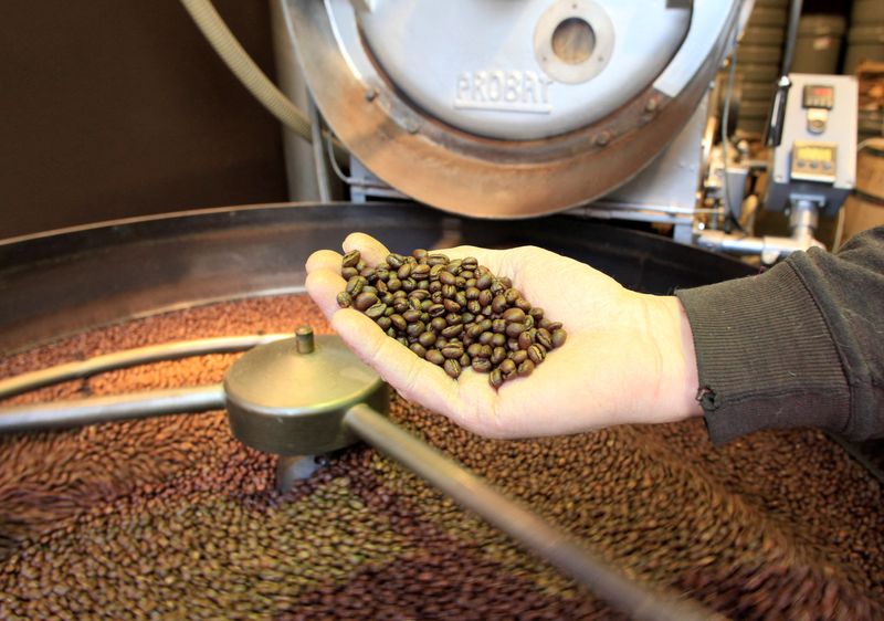 &copy; Reuters. FILE PHOTO: An employee checks freshly roasted coffee beans during cooling down in a tumbler at H. Schwarzenbach coffee roastery in Zurich, Switzerland December 4, 2018. REUTERS/Arnd Wiegmann/File Photo