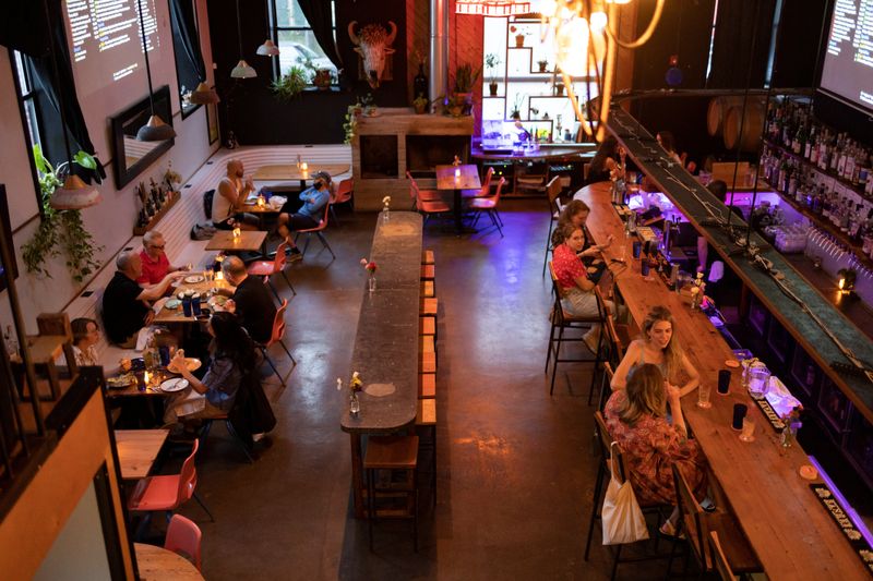 © Reuters. Customers drink and dine inside the restaurant 