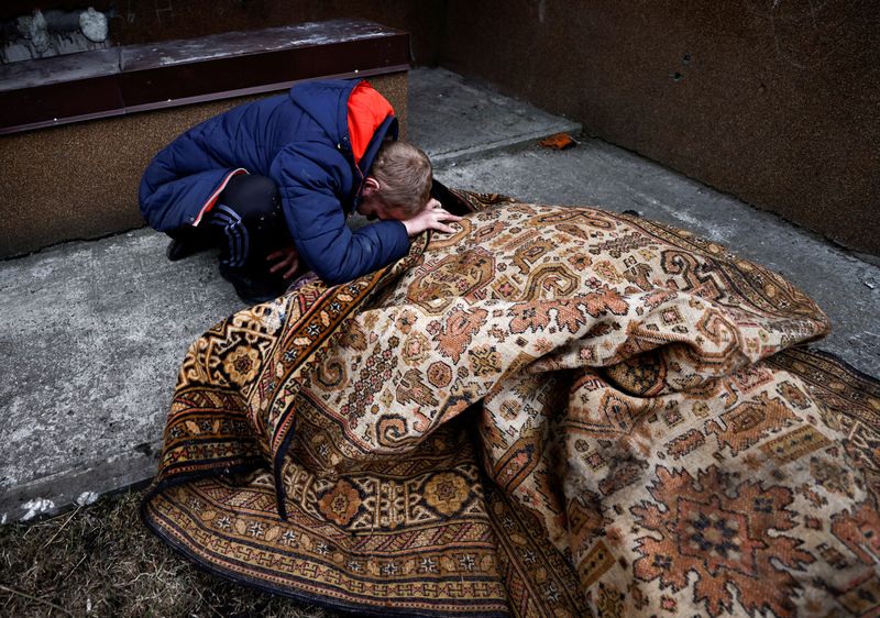 &copy; Reuters. Serhii Lahovskyi, de 26 años, llora junto al cuerpo de su amigo Ihor Lytvynenko, quien según los residentes fue asesinado por soldados rusos, después de que lo encontraron junto al sótano de un edificio, en medio de la invasión rusa de Ucrania, en Bu