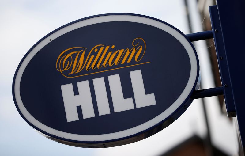 &copy; Reuters. FILE PHOTO: Signage is seen outside a William Hill betting shop in Manchester, Britain, September 9, 2021. REUTERS/Phil Noble