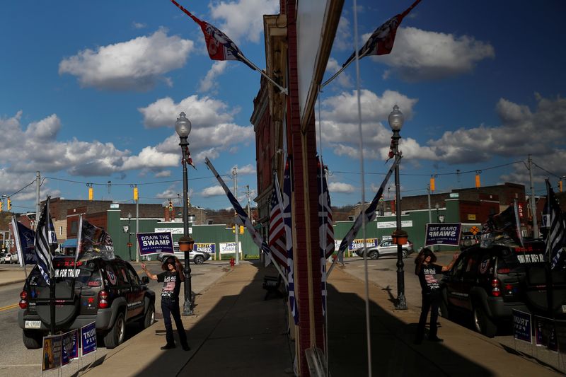 &copy; Reuters. FILE PHOTO: A supporter of U.S. President Donald Trump holds a campaign sign outside the Republican headquarters in Union City, Pennsylvania, U.S., October 23, 2020.  REUTERS/Shannon Stapleton/File Photo