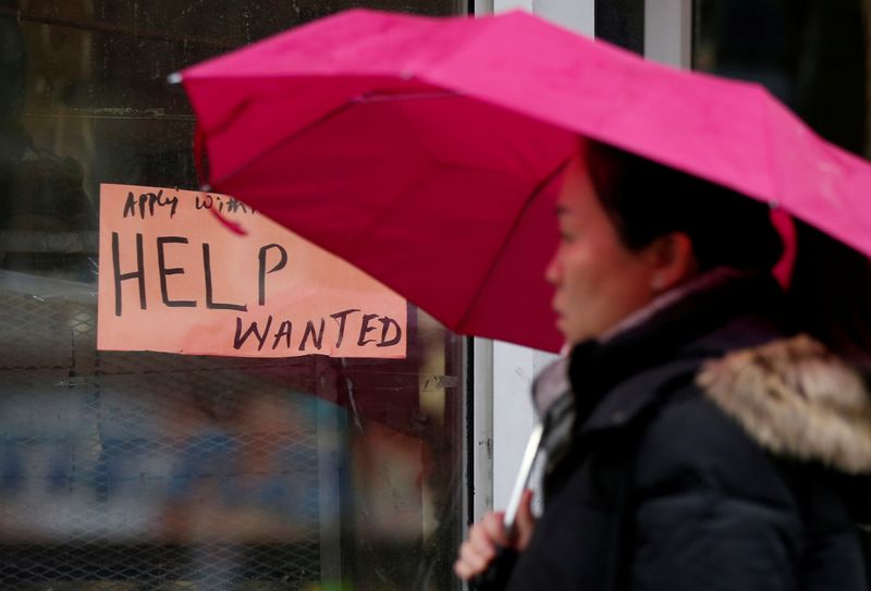 &copy; Reuters. FILE PHOTO: A woman walks past a "Help wanted" sign at a retail store in Ottawa, Ontario, Canada, November 2, 2017. REUTERS/Chris Wattie