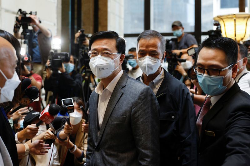 &copy; Reuters. Former Hong Kong Chief Secretary for Administration John Lee, arrives at his office after Central People's Government approves his resignation, in Hong Kong, China, April 8, 2022. REUTERS/Tyrone Siu