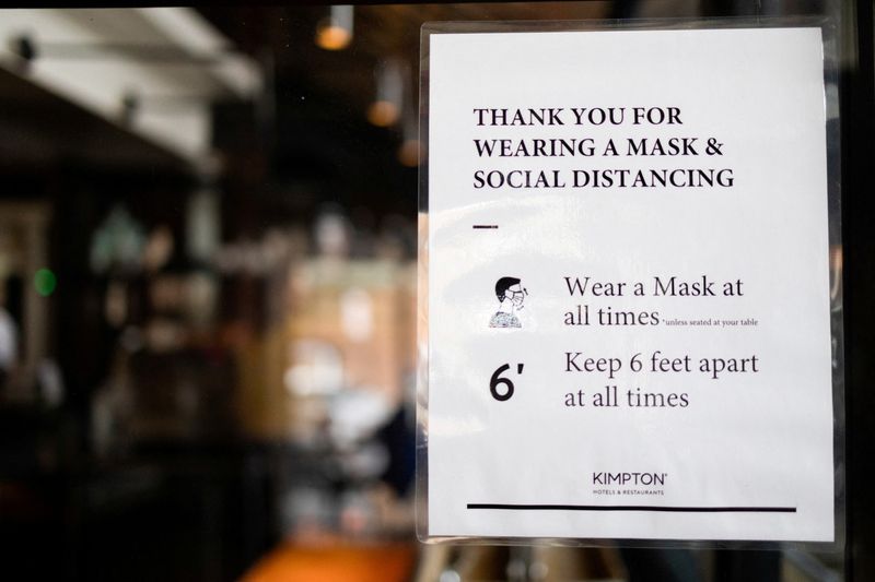 &copy; Reuters. FILE PHOTO: A sign is seen at a dining area that has been modified to prevent the spread of coronavirus disease (COVID-19) at the Kimpton Hotel Monaco in Philadelphia, Pennsylvania, U.S., April 7, 2021.  REUTERS/Hannah Beier/File Photo