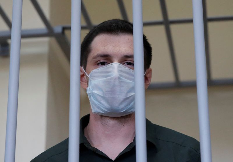 &copy; Reuters. FILE PHOTO: Former U.S. Marine Trevor Reed, who was detained in 2019 and accused of assaulting police officers, stands inside a defendants' cage during a court hearing in Moscow, Russia July 30, 2020. REUTERS/Maxim Shemetov/File Photo