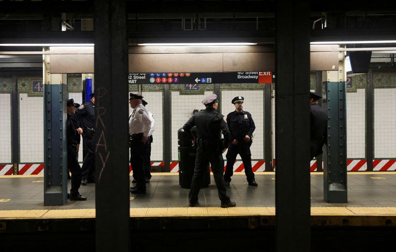 &copy; Reuters. Law enforcement officers work at Times Square subway station, after a shooting at a subway station in Brooklyn, in Manhattan, New York City, New York, U.S., April 12, 2022. REUTERS/Jeenah Moon