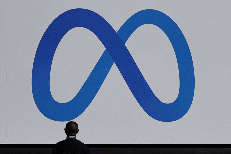 &copy; Reuters. FILE PHOTO: man stands in front of a sign of Meta, the new name for the company formerly known as Facebook, at its headquarters in Menlo Park, California, U.S. October 28, 2021. REUTERS/Carlos Barria/File Photo