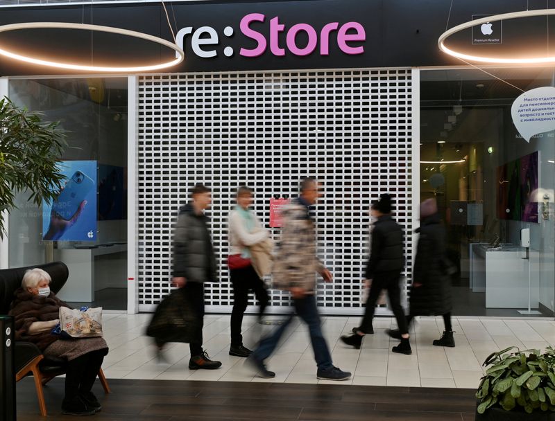 &copy; Reuters. FILE PHOTO: People walk past a closed "re:Store" Apple reseller shop at a mall in Omsk, Russia March 2, 2022. REUTERS/File Photo