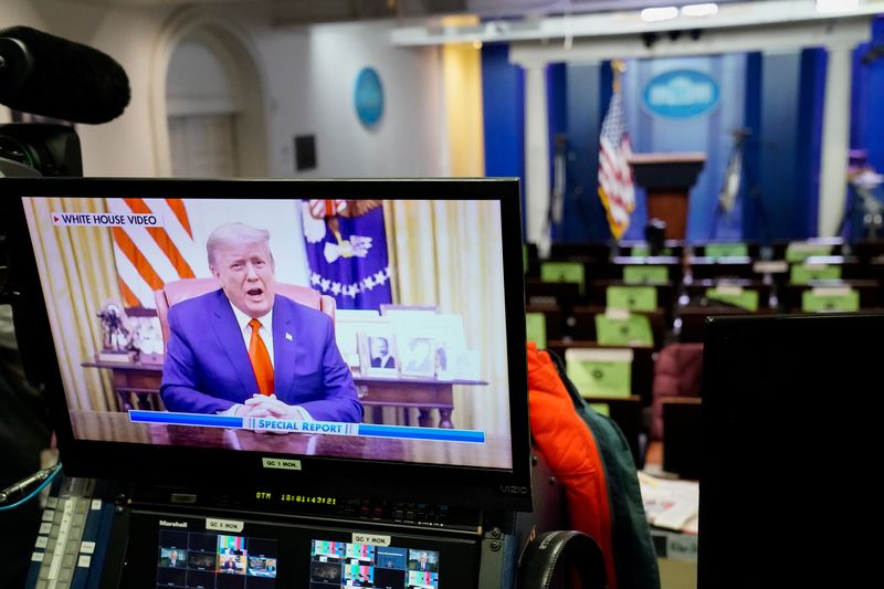 &copy; Reuters. A pre-recorded video of U.S. President Donald Trump addressing the U.S. Capitol riot is seen playing on a television in the White House briefing room in Washington, U.S., January 13, 2021. REUTERS/Erin Scott/File Photo