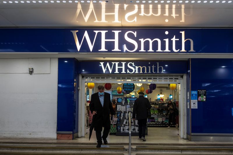 &copy; Reuters. FILE PHOTO: A person wearing a mask exits a branch of WH Smith in London, Britain, December 1, 2021. Picture taken December 1, 2021. REUTERS/May James