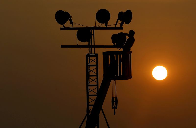 &copy; Reuters. FILE PHOTO: A man removes light bulbs on a temporary lamppost after an event in Colombo, Sri Lanka February 25, 2019. REUTERS/Dinuka Liyanawatte 