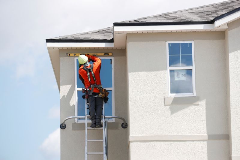 &copy; Reuters. FILE PHOTO: A carpenter works on new townhomes that are still under construction while building material supplies are in high demand in Tampa, Florida, U.S., May 5, 2021.  REUTERS/Octavio Jones/File Photo