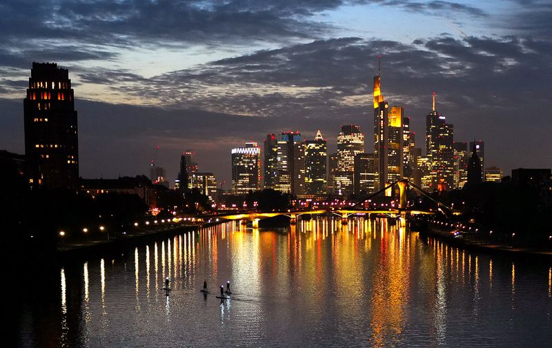 &copy; Reuters. FILE PHOTO: Stand-up paddlers are seen on river Main during sun set behind the skyline with the banking district in Frankfurt, Germany, October 18, 2021.  REUTERS/Kai Pfaffenbach