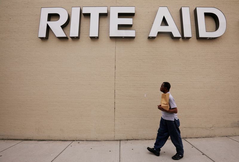 &copy; Reuters. FILE PHOTO: A pedestrian passes a sign for a Rite Aid pharmacy in Somerville, Massachusetts, U.S., June 29, 2017. REUTERS/Brian Snyder