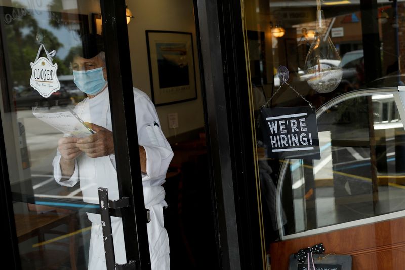 &copy; Reuters. FILE PHOTO: A "We're Hiring" sign advertising jobs is seen at the entrance of a restaurant in Miami, Florida, U.S., May 18, 2020. REUTERS/Marco Bello/File Photo