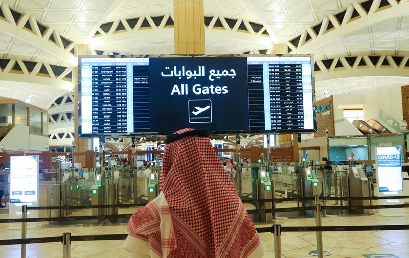 &copy; Reuters. FILE PHOTO: A Saudi man checks the flight timings at the King Khalid International Airport in Riyadh, Saudi Arabia, May 16, 2021. REUTERS/Ahmed Yosri