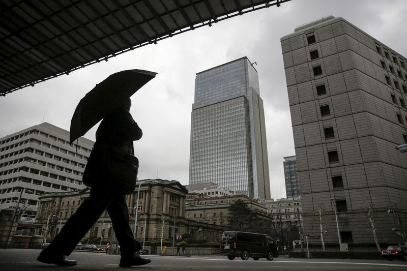 &copy; Reuters. FILE PHOTO: A businessman walks near the Bank of Japan headquarters in Tokyo, Japan, Feb. 15, 2016. REUTERS/Thomas Peter/File Photo/File Photo