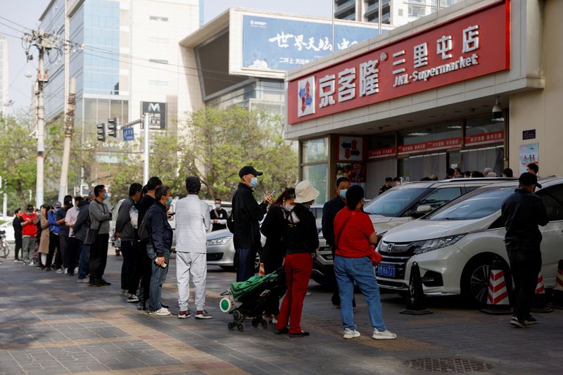 &copy; Reuters.     中国北京市は、新型コロナウイルスの大規模検査を市内の大半の地区に拡大した。買い物のため並ぶ人たち、北京市内、同日撮影（２０２２年　ロイター／Carlos Garcia Rawlins）