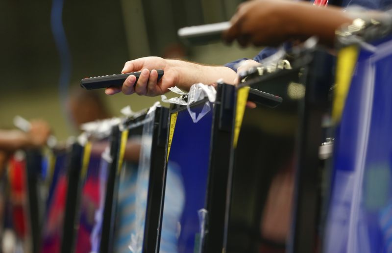 © Reuters. FILE PHOTO: Workers use remote controls to check television sets before they are repackaged at Element Electronics in Winnsboro, South Carolina May 29, 2014.  REUTERS/Chris Keane/File Photo