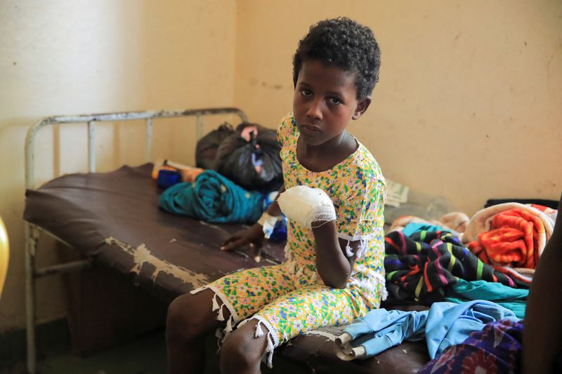 &copy; Reuters. A child who lost his left hand from an explosive left near his house in the aftermath of a fight between the Ethiopian National Defence Forces (ENDF) and the Tigray People's Liberation Front (TPLF) forces, receives treatment in Dubti Referral Hospital, in