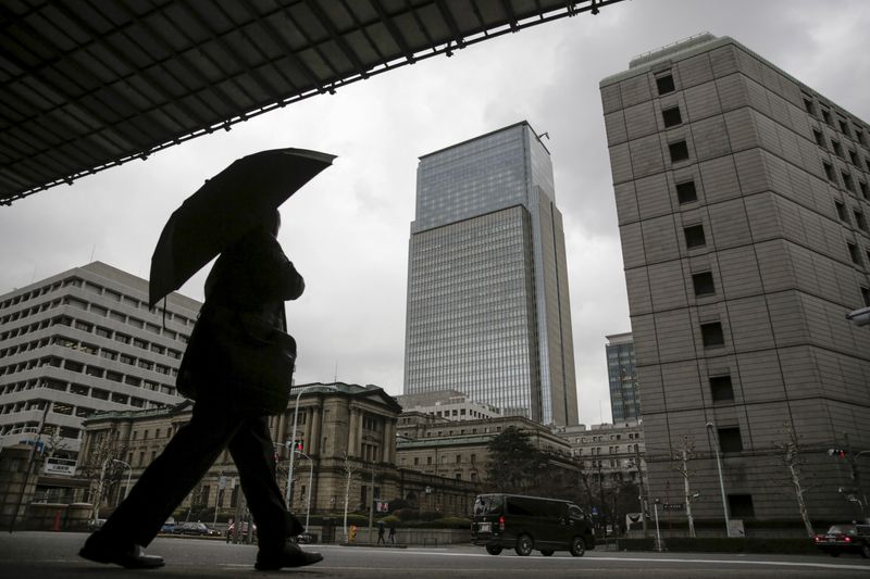 &copy; Reuters. FILE PHOTO: A businessman walks near the Bank of Japan headquarters in Tokyo, Japan, Feb. 15, 2016. REUTERS/Thomas Peter/File Photo