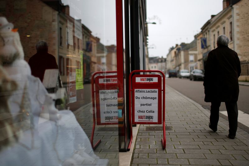 &copy; Reuters. FILE PHOTO: A man walks past a placard which reads "Lactalis Affair, partial unemployment at Celia factory" in the streets in Craon, western France, January 12, 2018.   REUTERS/Stephane Mahe/File Photo