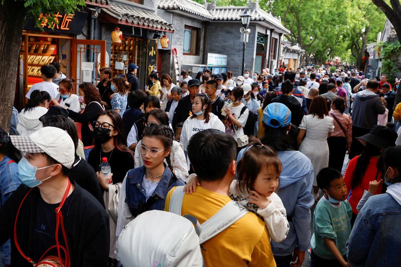 &copy; Reuters. FILE PHOTO: People walk along Nanluoguxiang alley during the Labour Day holiday, following the outbreak of the coronavirus disease (COVID-19), in Beijing, China May 4, 2021. REUTERS/Carlos Garcia Rawlins